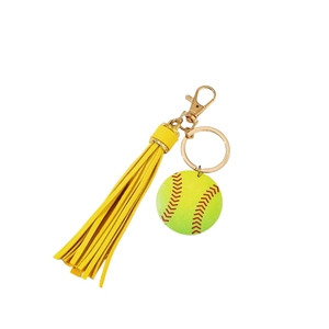 Miniature softball keychain with yellow leather tassel and golden lobster clasp on white background