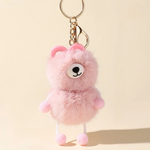 Close-up of pink faux mink fur bear keychain with golden metal clasp and fluffy texture