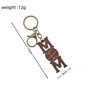Detailed view of MOM wooden keychain with rugby motif showing size 13cm and weight 12g