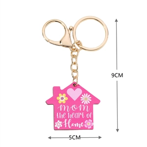 Pink house pendant keychain for Mother's Day with dimensions 9cm by 5cm on white backdrop