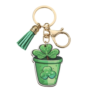 Detail of St. Patrick's Day clover keychain with green tassel and gold metal clasp