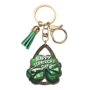 Detail of St. Patrick's Day keychain with green tassel and wood charm with clover motifs