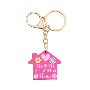 Detailed close-up of pink house-shaped keychain for Mother's Day with golden lobster clasp