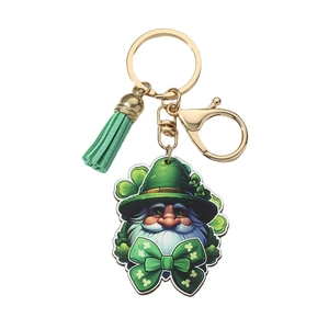 Macro view of St. Patrick's Day gnome keychain with green tassel and gold metal clasp