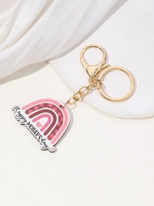 Detail of pink rainbow MAMA keychain with Happy Mother's Day text on white pedestal