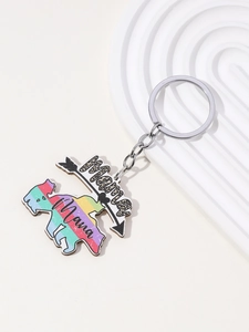 Detail of pink leopard print Mama keychain with rainbow charm on white display tray