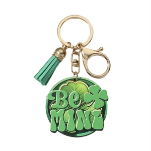 Detail view of St. Patrick's green clover keychain with Be MINE text and green tassel
