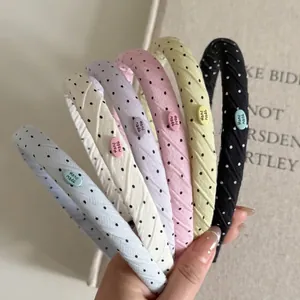 Set of six retro polka dot headbands in pastel colors featuring a handmade label