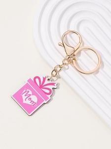 Detailed view of pink gift box charm with Mom text and golden lobster clasp keychain