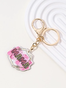 Detailed close-up of Mother's Day keychain with pink leopard print MAMA text and gold hardware