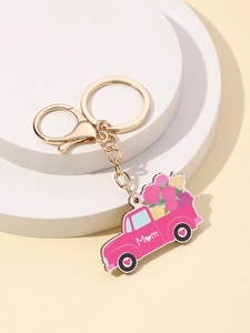 Détail du porte-clés camion rose avec lettrage Mama et décorations florales de fleurs