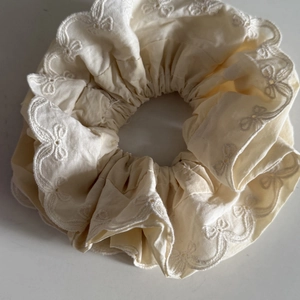 Elegant cream-colored double-layer lace scrunchie with floral embroidery and wavy edges