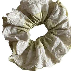 Dual-layer yellow and white lace scrunchie with intricate embroidery and floral wavy edges