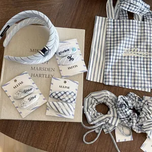 Blue and white striped hair accessory set with headband, scrunchies, and cloth bag