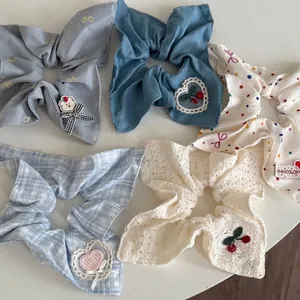 Set of five blue and white style bow scrunchies with lace, embroidery and dot patterns