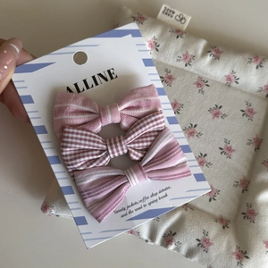 Pink striped and checkered bow hair clips set on a display card for girls