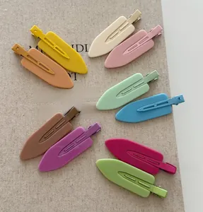 Set of 10 colorful matte macaron seamless hair clips arranged on a textured surface