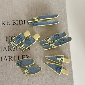 Denim blue and yellow hair clip set featuring small bows and textured fabric wrapping