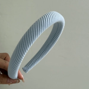 Detailed macro view of light blue ribbed fabric texture on the padded headband