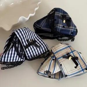 Three nautical style plaid bow hair claws with black lace trim and golden charms