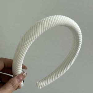 Close-up of white thickened headband featuring spiral fabric texture for hair styling