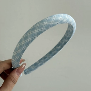 Detail shot of the blue and white plaid fabric texture on a padded headband