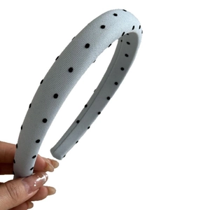 Chic light blue sponge headband with black polka dots for a high cranial top look
