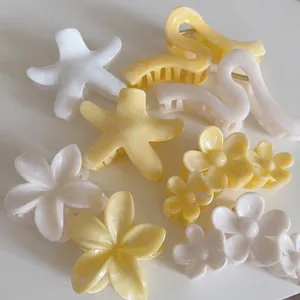 Pinces à cheveux en acétate crème et jaune en forme de fleur et d'étoile avec effet marbré