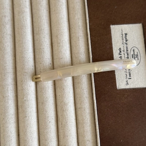 Detail of cream acetate hair clip with France Handmade lettering and gold fastener