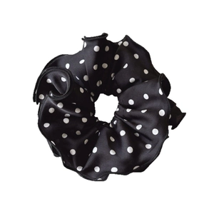 Elegant black satin scrunchie with white polka dots and delicate ruffled edges