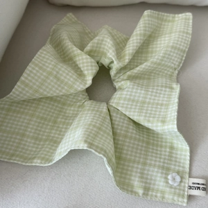 Green and white checkered lace scrunchie with a small floral button and brand woven label