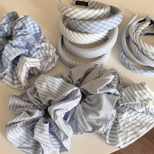 Detailed view of blue and white striped fabric headbands and scrunchies in Korean style