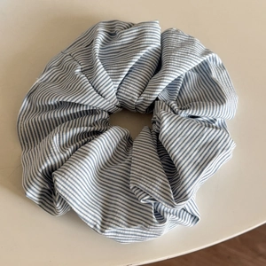 Chic blue and white striped fabric scrunchie with elastic band for daily hair styling