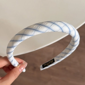 Close-up of blue and white striped fabric headband with detailed twill weaving texture