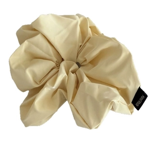 Oversized cream leather scrunchie with handmade label for minimalist ponytail styling