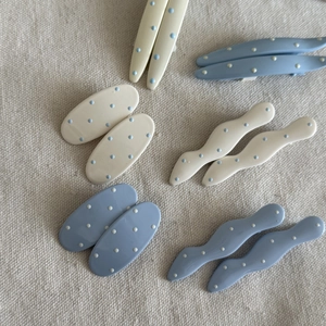 Polka dot hair clip set in pastel blue and cream featuring wavy and oval shapes