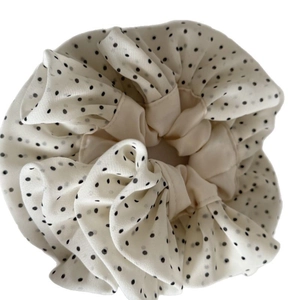 Sweet cream scrunchie with black polka dots and delicate lace trim for hair styling