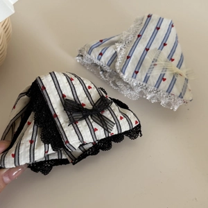 Close-up of heart pattern hair claw with striped fabric, lace edges and mesh bow detail