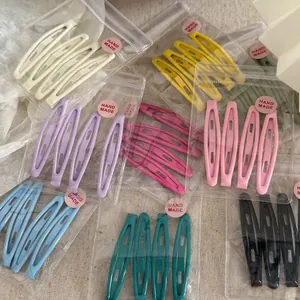 Lot de 4 barrettes BB en métal coloré aux tons macaron sur tissu en lin