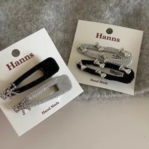 Sparkly silver bow hair clip set with glitter coating and rhinestones on card