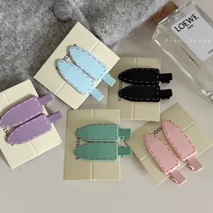Five-color pastel hair clips set with unique contrast stitching on card display