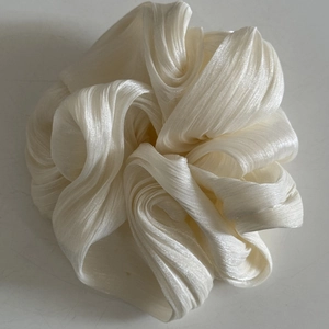Elegant cream pleated satin oversized scrunchie hair tie with silk glossy texture