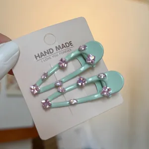 Elegant mint green hair clips with purple crystal petals for stylish side bangs