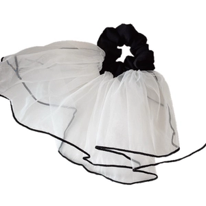 Elegant white mesh scrunchie with black trim detail for stylish ponytail styling