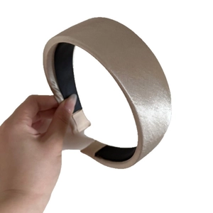 Elegant wide satin headband in champagne gold with a glossy finish and non-slip lining