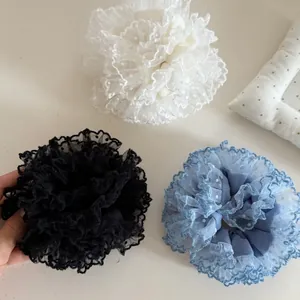 Three-piece set of mesh scrunchies in black, white, and blue with delicate lace polka dots