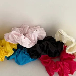 Set of six large solid color fabric scrunchies in pastel tones for elegant ponytails