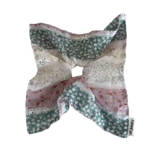 Oversized green floral scrunchie with patchwork square scarf design for elegant hair styling
