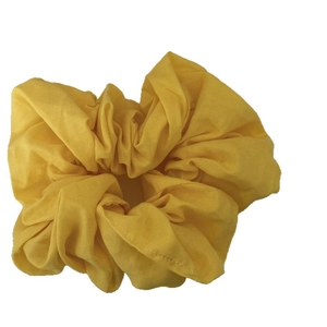 Solid yellow oversized fabric scrunchie with cotton pleats for bun and ponytail hairstyles