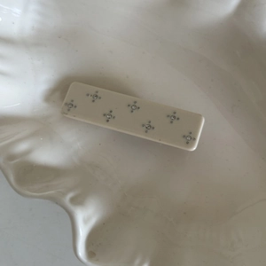 Close-up of cream acetate hair clip featuring star-shaped rhinestone embellishments